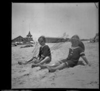 Elizabeth and Frances West sit in the sand, Venice, about 1910