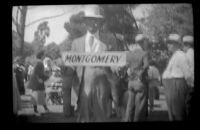 Ralph Hiatt holds a sign at the Iowa Picnic in Bixby Park, Long Beach, 1938