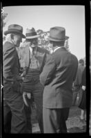 Three men talk to each other at the Iowa Picnic in Lincoln Park, Los Angeles, 1939