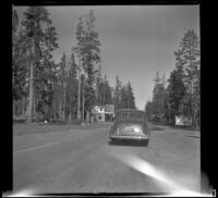 H. H. West's Buick approaches the west entrance to Yellowstone National Park, West Yellowstone vicinity, 1942