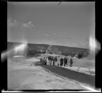 Tour group gathered around a vent in a geyser basin, Yellowstone National Park, 1942