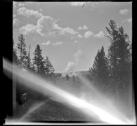 Daisy Geyser erupts in the distance, Yellowstone National Park, 1942
