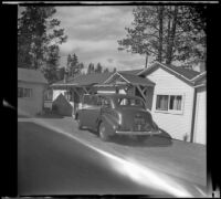 H. H. West's Buick parked in front of an auto court, West Yellowstone, 1942