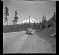 Mertie West poses with H. H. West's Buick in front of Mount Hood, Portland vicinity, 1942