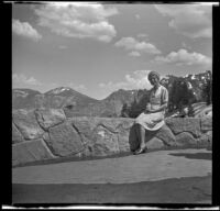 Mertie West sits on a parapet overlooking Crater Lake, Crater Lake National Park, 1942
