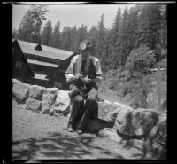 H. H. West feeding chipmunks, Oregon Caves National Monument, 1942