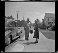 William D. Butler and Mertie West stand on the sidewalk outside the Butler residence, Napa, 1942