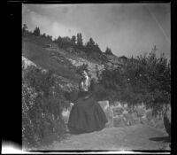 Ellen Lorene (Pinkie) Lemberger sits on a stone wall in Elysian Park, Los Angeles, 1901