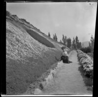 Ellen Lorene (Pinkie) Lemberger sits at the bottom of a hill at Elysian Park, Los Angeles, 1901