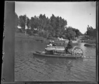 Man steers a bicycle boat with passengers on the lake at Hollenbeck Park, Los Angeles, about 1898