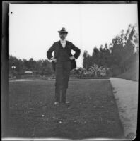 H. H. West stands with his hands on his hips in Hollenbeck Park, Los Angeles, about 1898