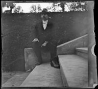 H. H. West sits at the side of stairs in Hollenbeck Park, Los Angeles, about 1898