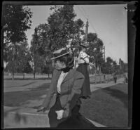 Daisy Kellum sits in Hollenbeck Park, Los Angeles, about 1898