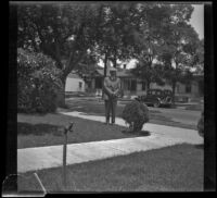 Wilson D. West stands in the front yard of the old West family residence on South Workman Street, Los Angeles, 1936