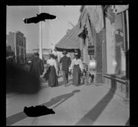 Soldier walks between two women, Los Angeles, about 1900