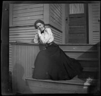 Daisy Kellum poses on the front porch steps of her home, Los Angeles, about 1899