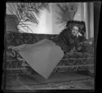 Daisy Kellum lounges on a sofa in her family's home, Los Angeles, about 1899