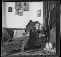 Earl Kellum lounges on a sofa in the Kellum family residence, Los Angeles, about 1899