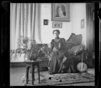Minnie Kellum poses on a sofa in her family's home, Los Angeles, about 1899