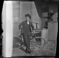 Earl Kellum poses with a bicycle in front of the Kellum residence, Los Angeles, about 1899