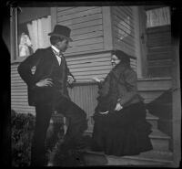 H. H. West and Daisy Kellum converse by the front porch stairs of the Kellum residence, Los Angeles, about 1899