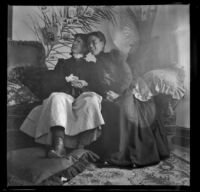 Earl Kellum and Minnie Kellum sit on their sofa and perform a scene from a play, Los Angeles, about 1899