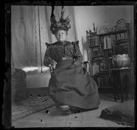 Lucretia Kellum sits and poses in a chair in her home, Los Angeles, about 1899