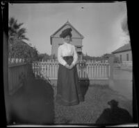 Mertie West poses in her front yard, Los Angeles, about 1898