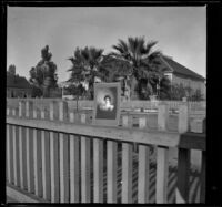 Portrait of Lizzie Chandler stuck on a fence, Los Angeles, about 1898