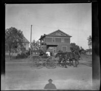 Horse-drawn carriage passes in front of the West's house, Los Angeles, about 1898