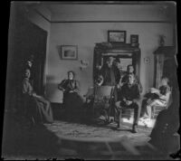 West family sits in their library with Daisy Kellum, Los Angeles, 1900