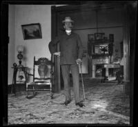 H. H. West stands in the parlor of the West's house at 240 South Griffin Avenue, Los Angeles, 1899