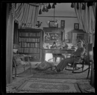 Wayne West and Wilson West sit in the library of the West's house, Los Angeles, about 1900
