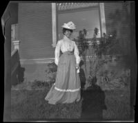 Mertie Whitaker stands in front of the West's house, Los Angeles, about 1900