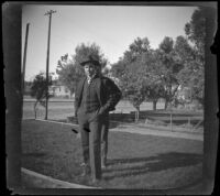 Guy West stands in the West's front yard while Arleigh Lemberger stands behind him, Los Angeles, about 1900