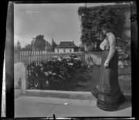 Ellen Lorene (Pinkie) Lemberger looks at flowers, Los Angeles, 1901