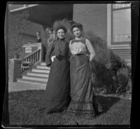 Mertie Whitaker and Ellen Lorene (Pinkie) Lemberger stand on the West's front lawn while Edwin Emery and Nella West stand on the porch, Los Angeles, 1901