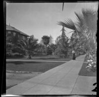 Ellen Lorene (Pinkie) Lemberger walks down Orange Grove Avenue, Pasadena, 1901