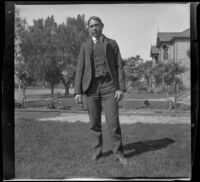 Guy West stands on the front lawn of the West's house, Los Angeles, about 1898