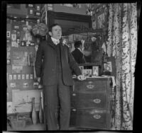 H. H. West poses next to the dresser in his bedroom, Los Angeles, about 1900