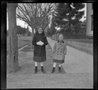 Elizabeth and Frances West stand on a street, Los Angeles, about 1912