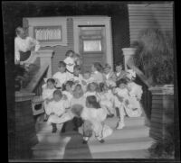 Group of children sits on the front steps of the West's house, Los Angeles, about 1907