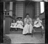 Mary West sits on the front steps of a house with her daughters, Elizabeth and Frances, as well as another girl, Los Angeles, about 1907
