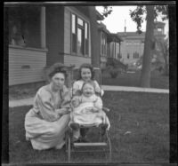 Mary West poses on a front lawn with her daughters, Elizabeth and Frances, Los Angeles, about 1907