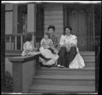 Mary West sits on the front steps of a house with her daughters, Elizabeth and Frances, as well as her cousin, Lola Bidwell, Los Angeles, about 1907