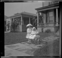 Elizabeth and Frances West pose on a front walk wearing white outfits, Los Angeles, about 1907