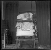 Elizabeth West sits in a highchair, Los Angeles, about 1903