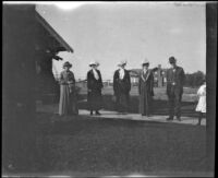 Mary West, Harriet Cline, Ida and Ambrose Teel, Frances West, and unknown woman stand on the front walk of 165 South Harvard Boulevard, Los Angeles, about 1912