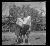 Elizabeth West and Frances Cline stand in the West's backyard, Los Angeles, about 1916