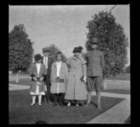 Frances West, William "Babe" Bystle, Elizabeth West, Mary West, and an unidentified soldier stand in the front lawn of the West's house, Los Angeles, about 1916